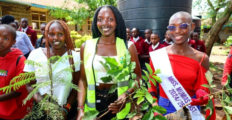 KAFU models join other participants in planting trees during the environmental sustainability initiative at Ruiru Boys High School.